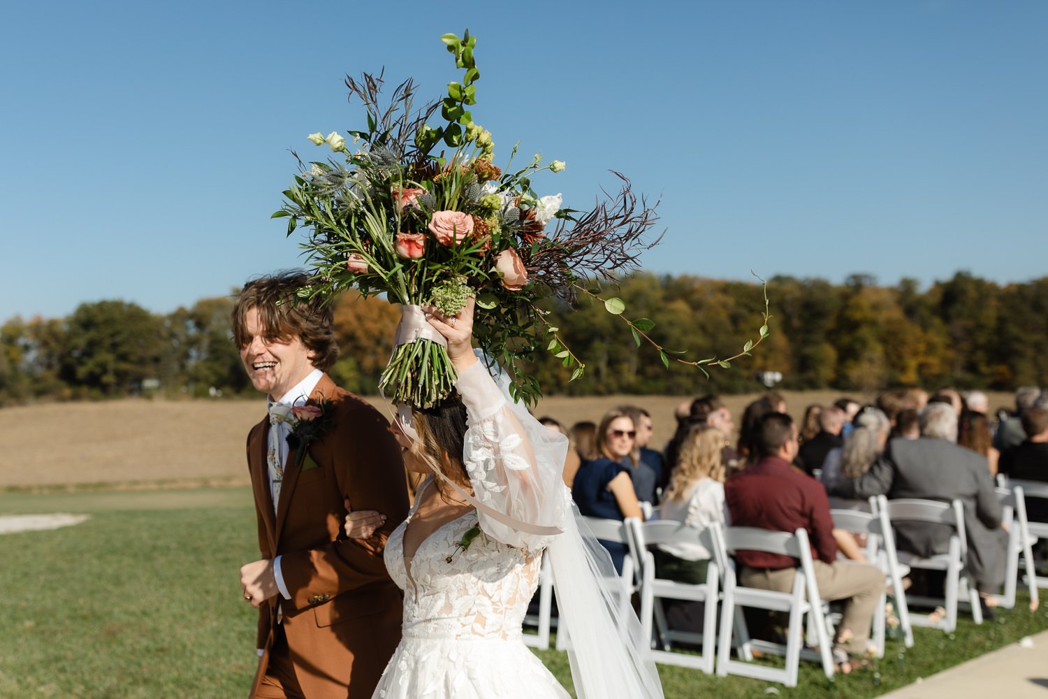 Bride and groom exiting their outdoor wedding ceremony at Ivory Meadows near Dayton, Ohio