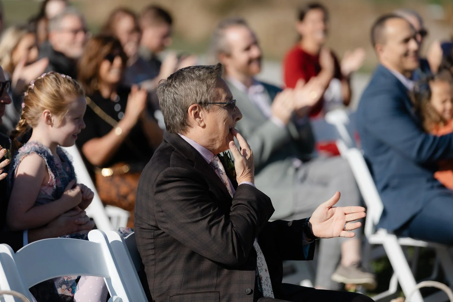 Guests applauding at the end of a fall outdoor wedding ceremony at Ivory Meadows