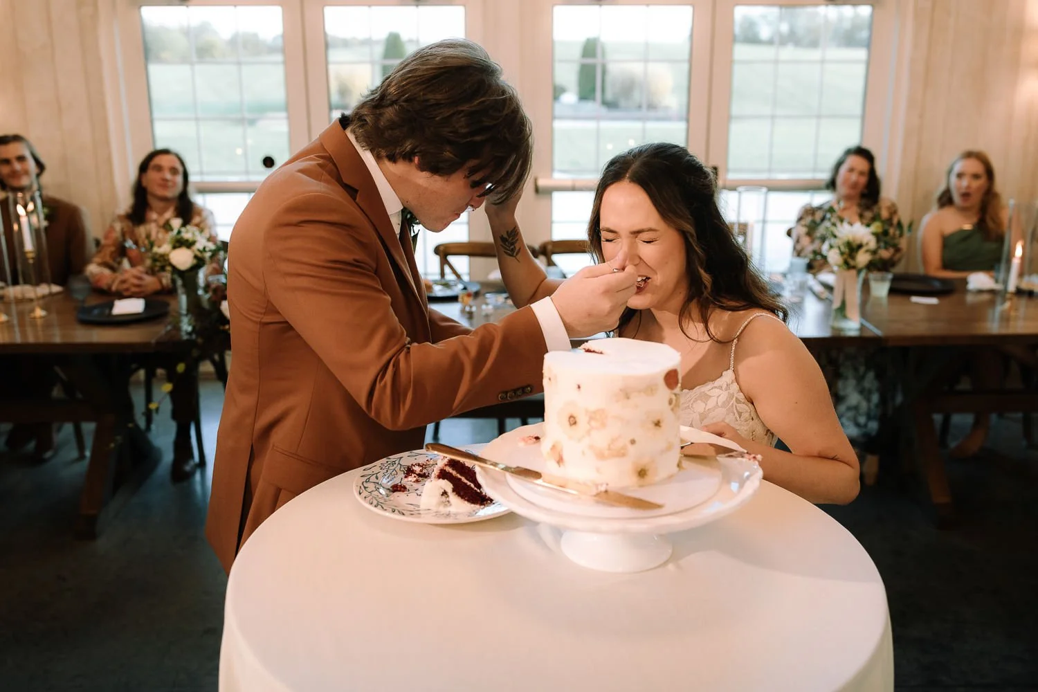 Bride and groom feeding each other cake during their Ivory Meadows wedding reception in Dayton Ohio