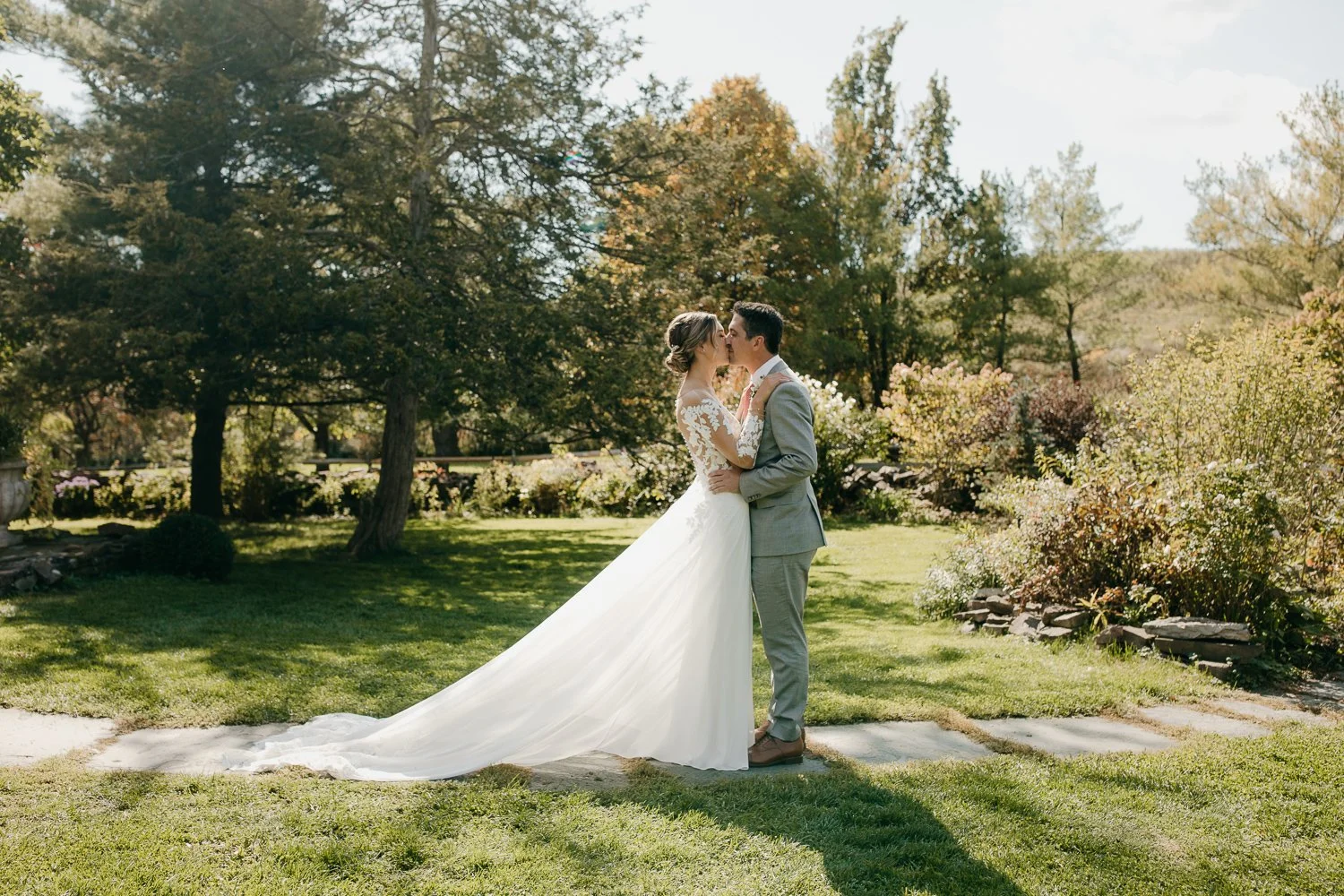 Couple sharing a kiss during their private vows in the garden at Windrift Hall in the Hudson Valley