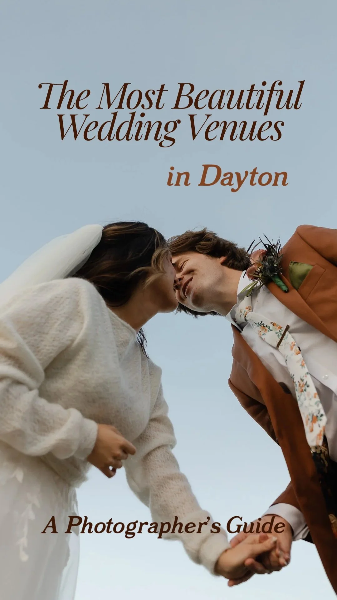 Low angle portrait of bride and groom kissing beneath open sky at a Dayton Ohio wedding venue.