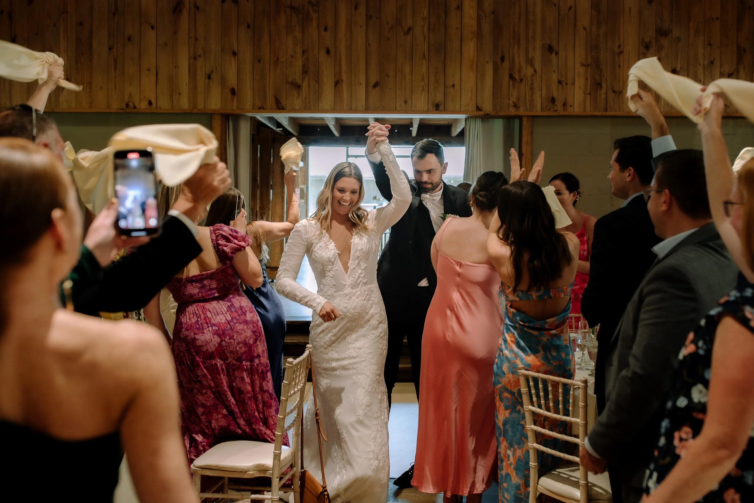 Bride and groom entering their reception inside the historic barn at Jorgensen Farms.