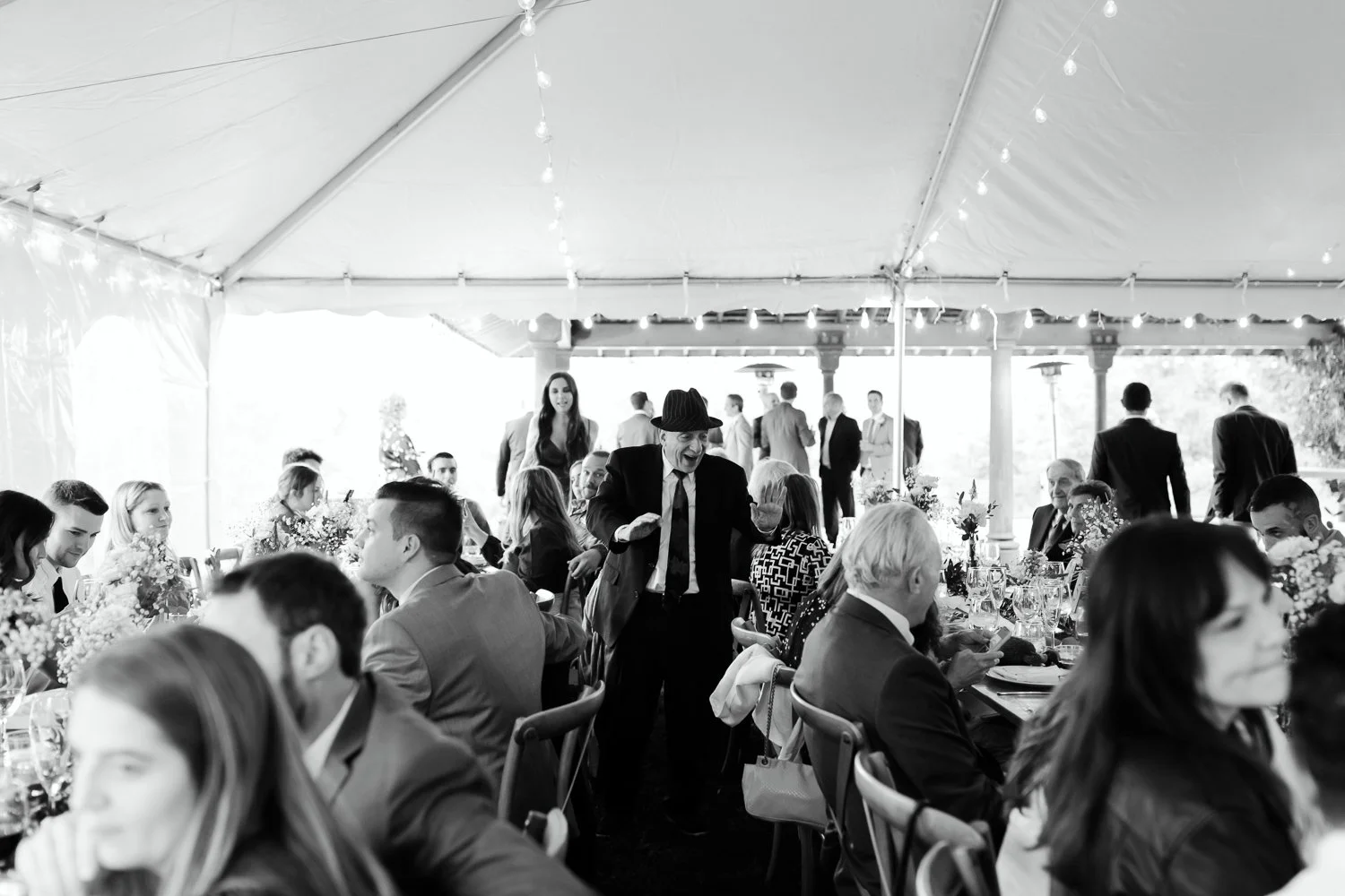 Guests gathered inside the reception tent during a Catskills wedding celebration