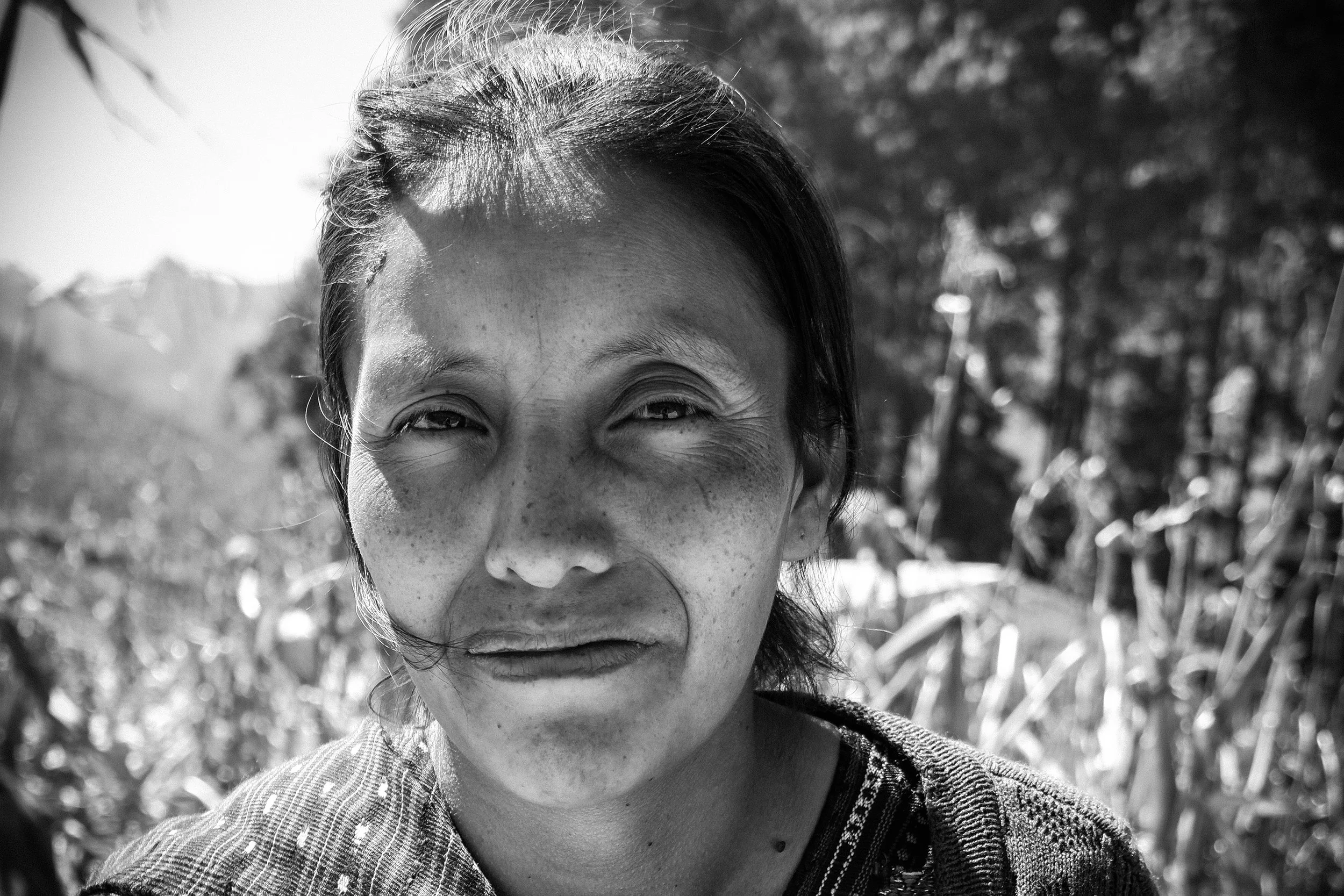 A Maya woman stands in a corn field in her village of Chuacorral, where she volunteers with the local NGO, Feed the Children, to help educate the woman of her village about proper nutrition, as malnourishment and food insecurity plagues the Maya population, of which the children suffer the most.