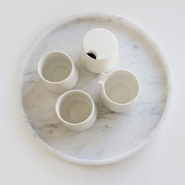  The new 'Round tray' in marble with porcelain vessels from the older 'Emily Tea Set',&nbsp;both by Evie Group. 