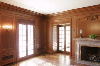 Mark Morton's home featured an abundance of architectural substance. The estate home featured 30 foot carved limestone columns and door surrounds. Three paneled rooms each paneled room was built of solid 7/8” hardwood and feature a 20' by 36; walnut paneled room with its seven French door units with cast brass hardware, an oversize Italian marble fireplace surround and walnut and oak parquet floors. Hand carved floral ropes and swags graced doorways and window headers and a 7 piece crown molding completed the room. Two additional paneled rooms were placed on the second. One being a rosewood bedroom with a connecting library of quarters-sawn oak. Both with featured over-sized decorative mantles. Various parts of this historical home were broken up and spread across the country, Architectural Antiques took the three salvaged rooms back to Minneapolis, and they were reconstructed piece by piece in our showroom. The walnut room has already found a new home in Aberdeen, South Dakota. Its master craftsmanship and warmth will be appreciated for years to come.