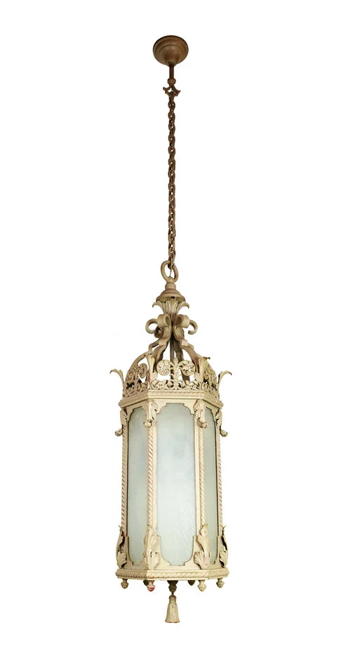 Six Sided 48" Pendant Iron & Glass This tall iron theater light makes a definite statement piece. The iron body and chain compliments textured glass on each of the six sides. The details on this light are bold: a chunky metal tassel hangs from the bottom and a heavy chain suspends it from the ceiling, while detailed floral filigree adds adds a sense of delicacy and grace.. THERE ARE 7 OF THESE!