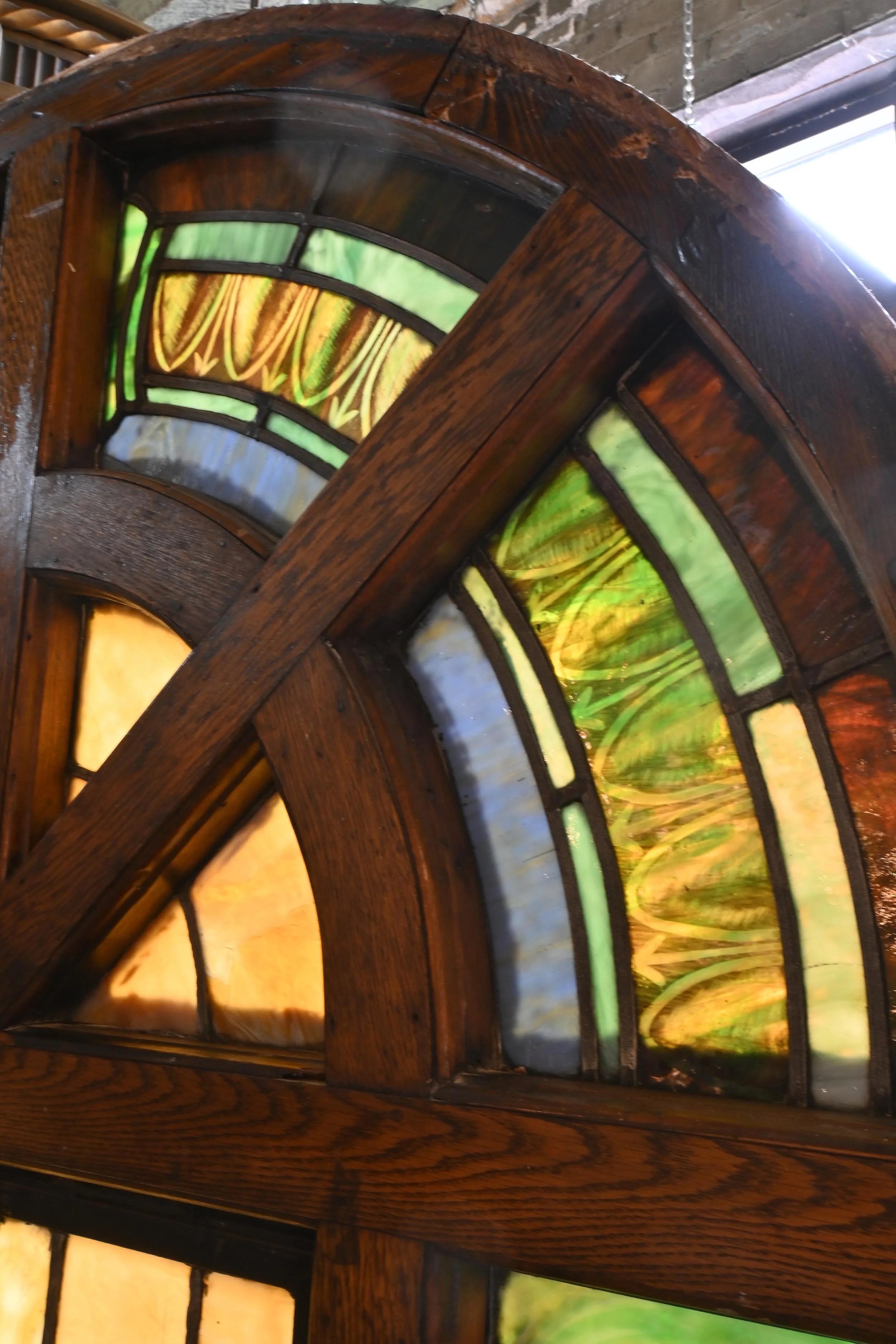 larger roman (true) arched windows divided stained glass