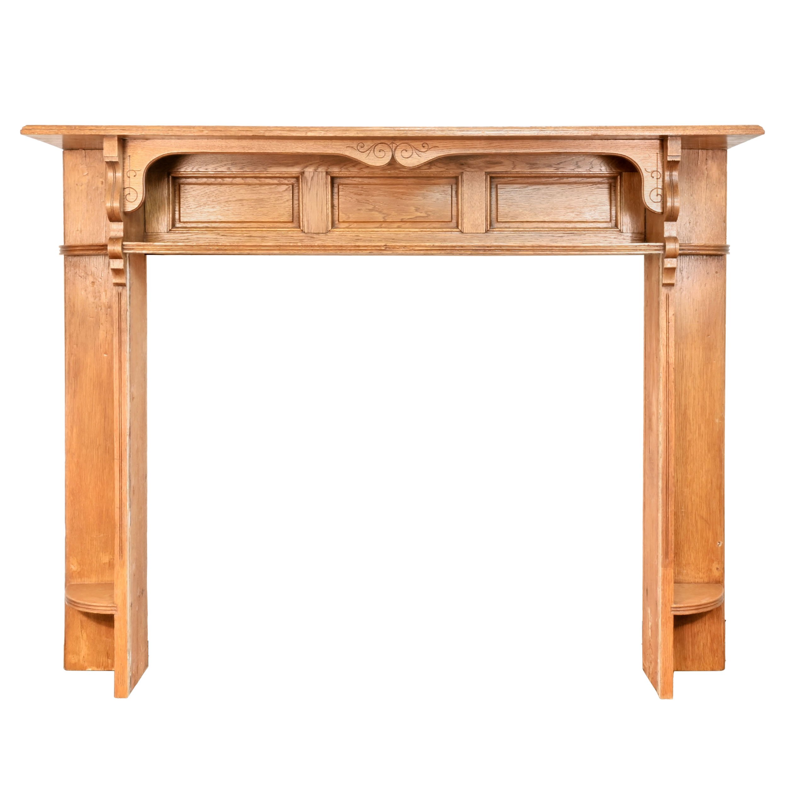 paneled oak mantel with shelves and hand carved scroll details