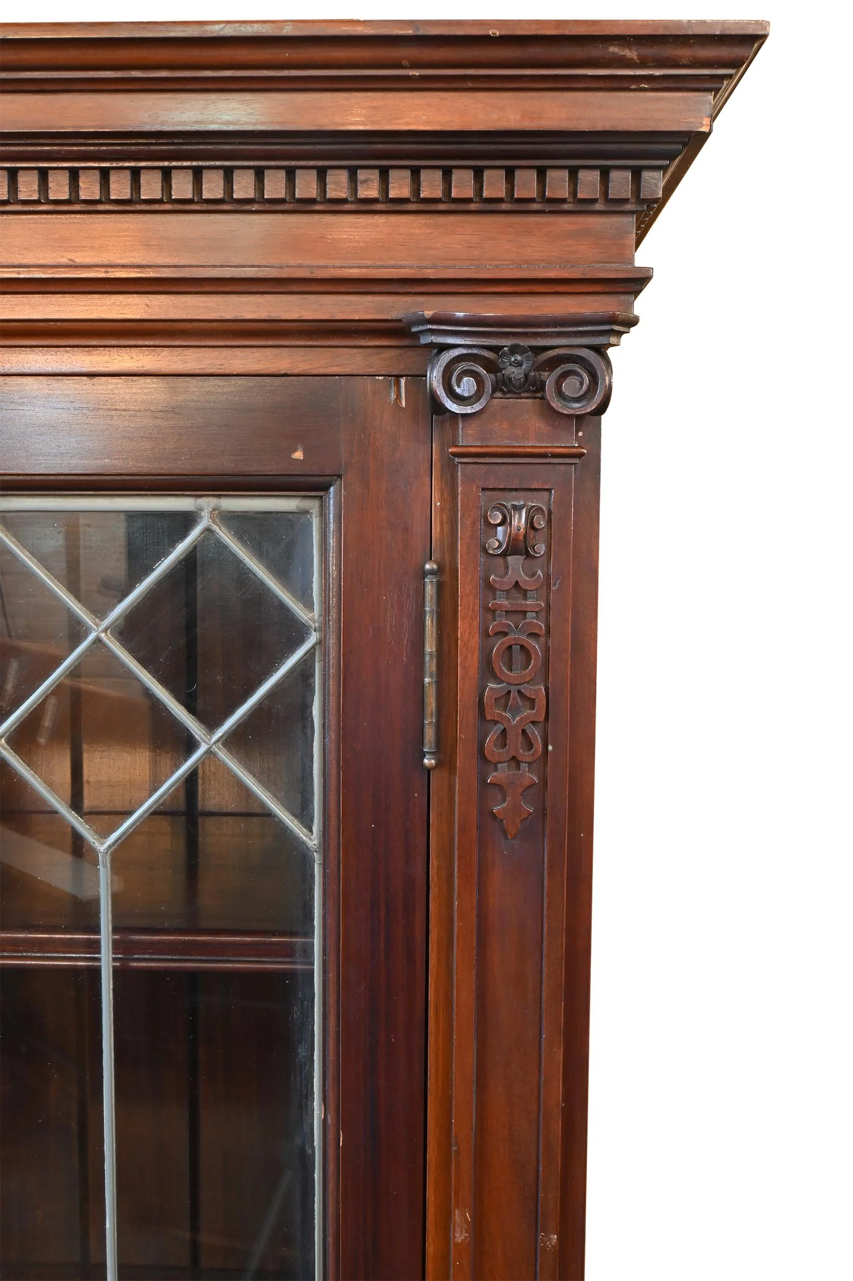 mahogany leaded glass door enclosed bookcase with carved details