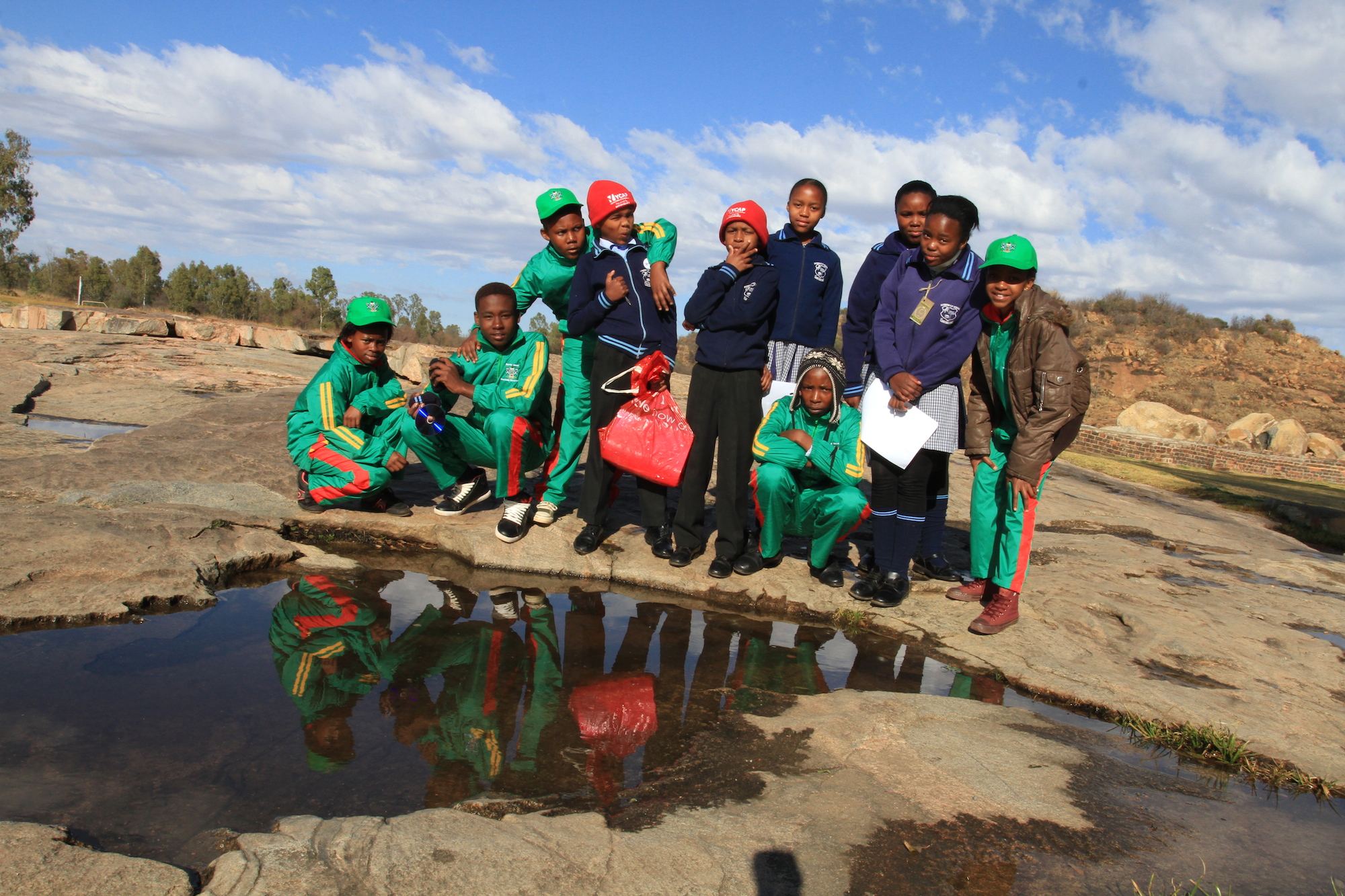 learners on rocks with reflection.jpeg