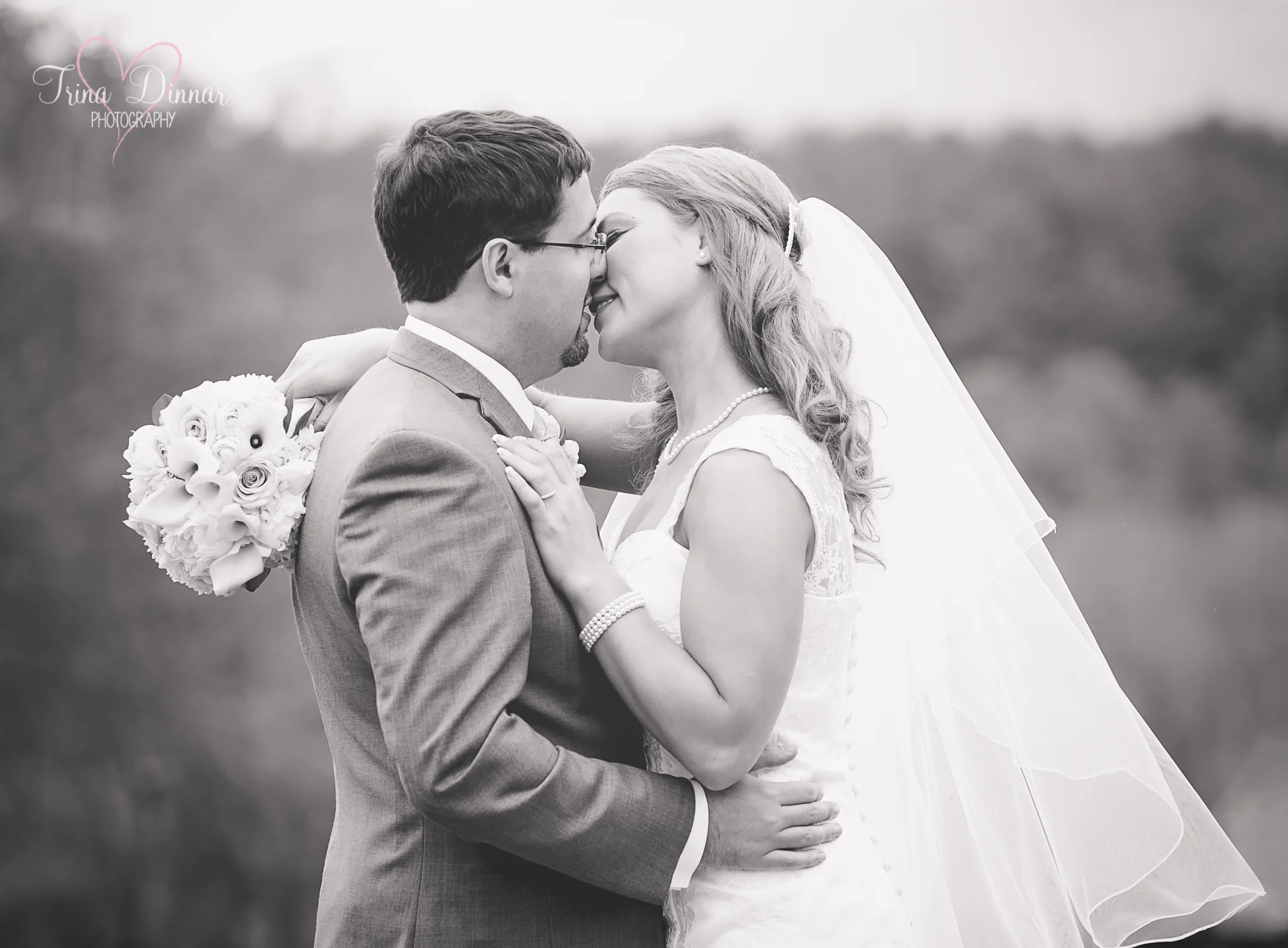 Maine wedding photographer, Trina Dinnar Photography captures kiss from bride and groom.