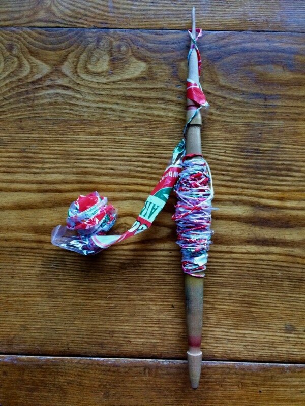 Adding twist to strips of plastic bread bags with a Bulgarian spindle. I did this about a year ago, trying to quit wasting so much plastic. I wanted to crochet bags from it, but then would need to learn crochet.