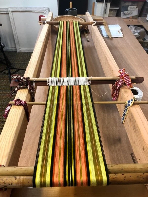 The circular warp is wound directly onto the loom bars, using a frame of 2 x 4’s. The string heddles are added as the warp is wound. Preparing the 2 x 4’s and setting this up were a necessary part of the process of incorporating this type of weaving into my life. Last time, I warped using a wooden ladder, which sort of worked.