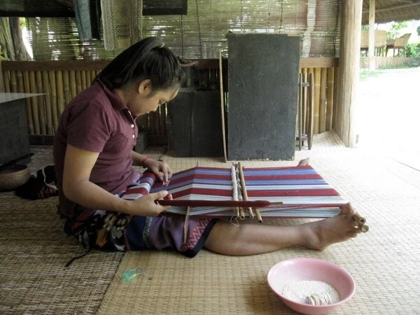 Compare with Keo’s feet and toes, which are fully engaged in the work - not simply applying force, but holding, manipulating, and controlling the tension of the loom bars.  In this video,  you can see that her feet are continuously making micro-adjustments as she works, then completely changing position to loosen the tension when the heddled shed is opened. Her toes work separately to hold the bars in different ways. It’s so cool to watch!