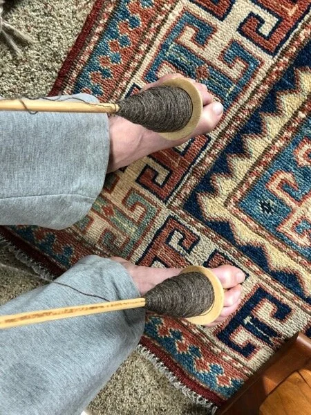 Toes are good for holding Peruvian spindles while winding a plying ball, too.