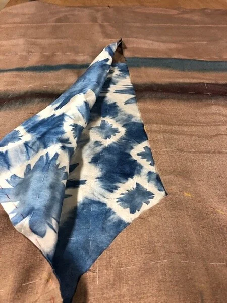 Cutting open the front from the neck down.