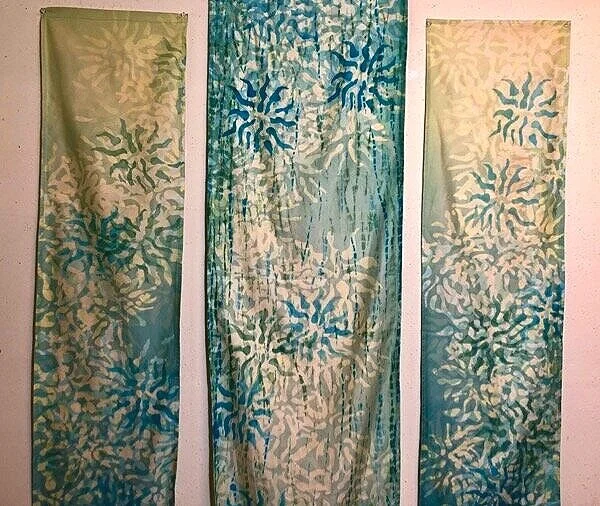 Triptych made in Stanley’s class, using the  eleko  technique of wax resist. The wax was applied with wood blocks, which I cut and made myself. Stanley convinced me to make a “negative space” block, with the pattern removed from the block, to add depth and texture to the resist dyed design. The middle panel has an underdye of  elo , the technique of binding and wrapping.