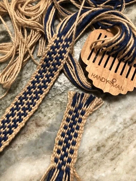 Brown and blue warp-faced band, 5/2 cotton, weaving in progress with small rigid heddle. Short sample with different warp scheme, woven with string heddles.
