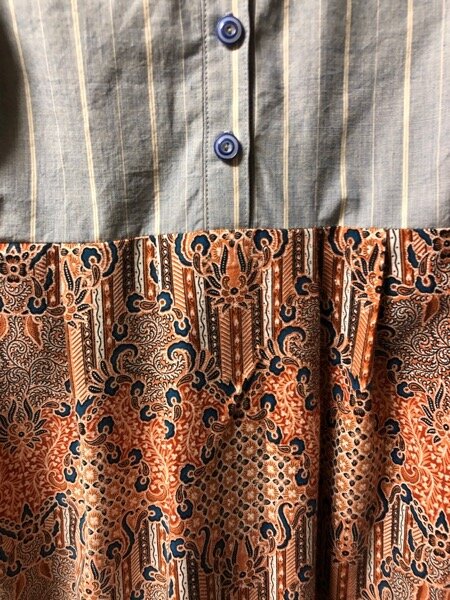 Detail of dress, Japanese striped shirting on top, China buttons, Thai sarong on the bottom. Soothing blue and muddy cinnamon….
