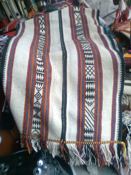 A weaving Um Hamad made in 2011, spinning and dyeing the yarn before weaving. Repeated rows of black diamonds again frame improvised sections of pickup.