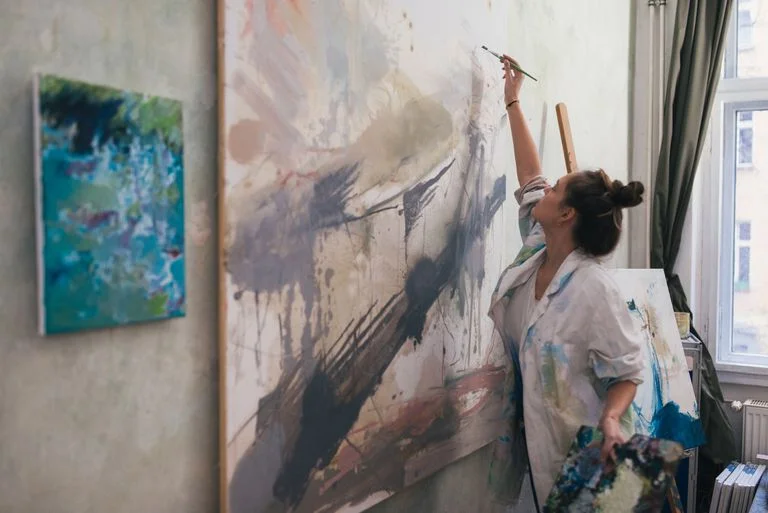 woman-painting-a-big-work-in-studio--893676154-5ad11467a474be0036384fce.jpg