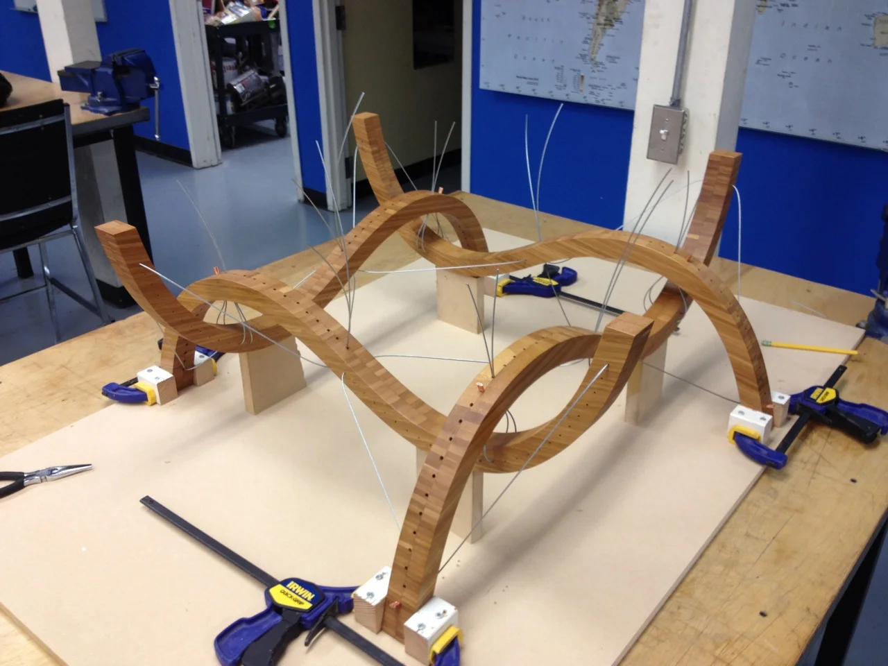 After receiving a thin layer of polyurethane, the curves are placed in a jig and wiring commences.