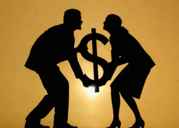 Man and Women Holding Dollar Sign.JPG
