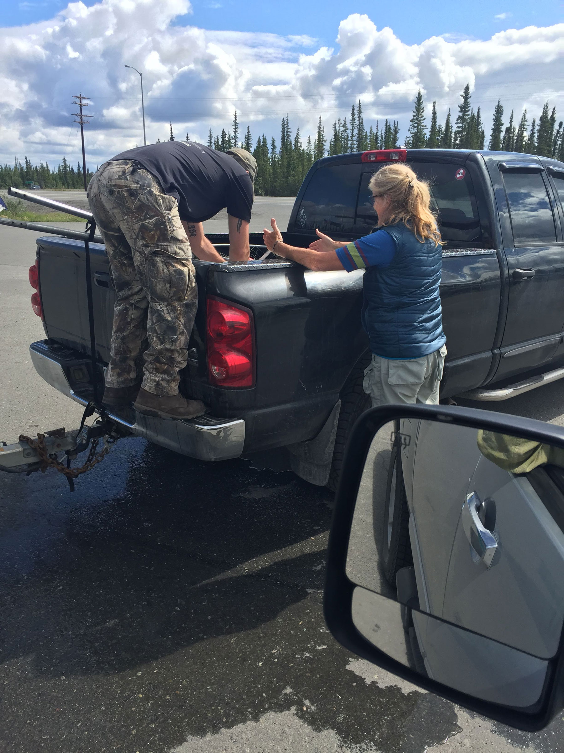 unpacking our truck with the big Alaskan sky in the background