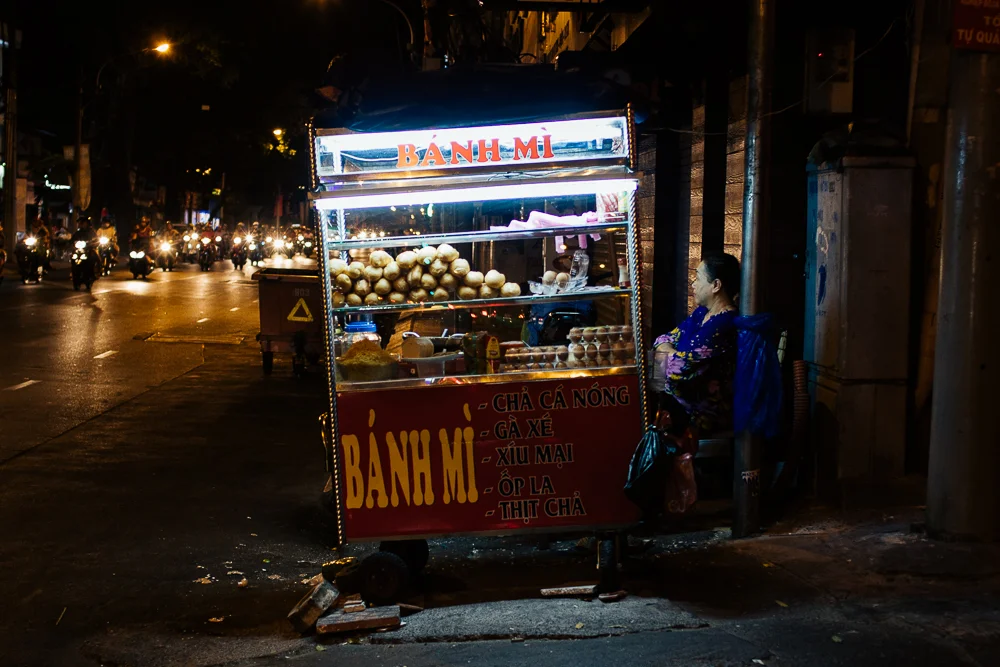 Bánh mì carts are everywhere -- they're sandwiches filled with egg, meat, cucumber, cilantro, and chili sauce on flaky, baguette-like bread made with wheat and rice flour. Convenient, cheap breakfast.