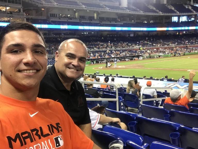 Jake Anchia with his father at a Miami Marlins game. Photo from The Miami Herald .