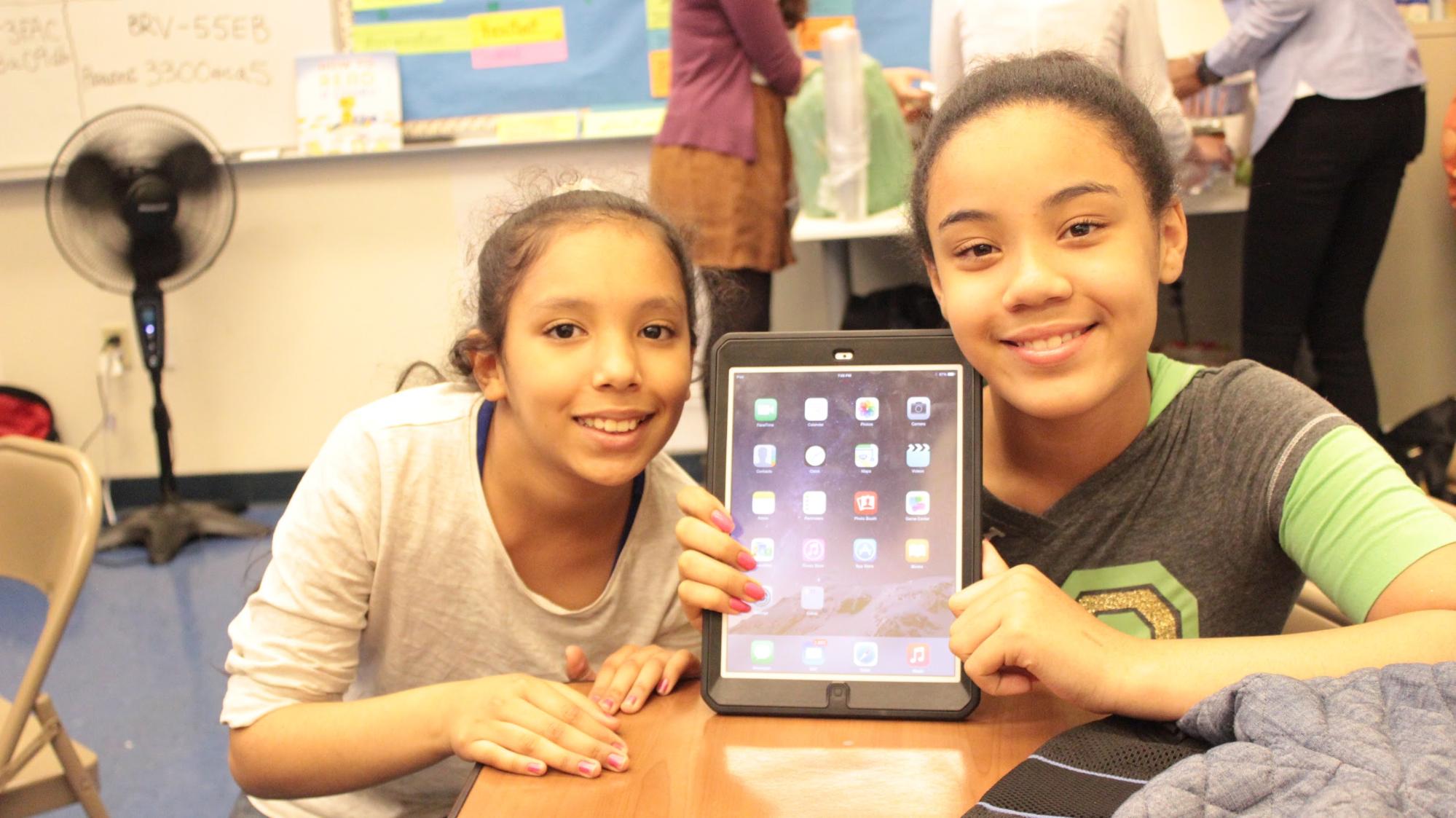 Siblings receiving their iPad to take home!