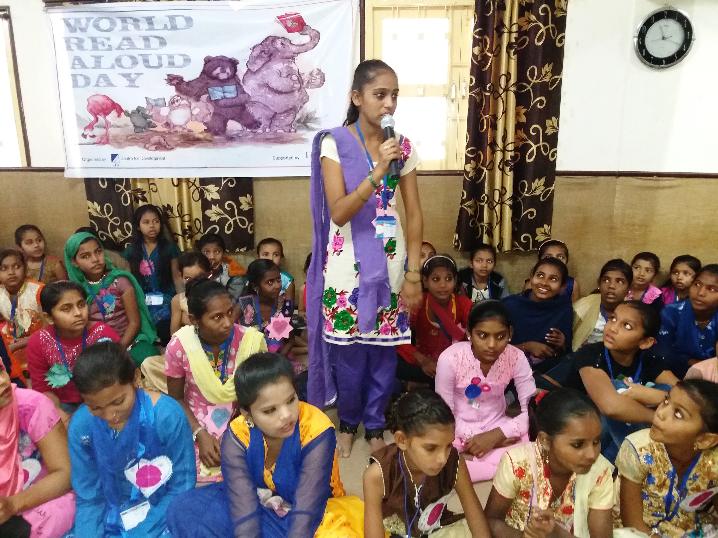 A LitKid at Center for Development in Ahmedabad, Gujarat, India, shares a story aloud with her peers on World Read Aloud Day.