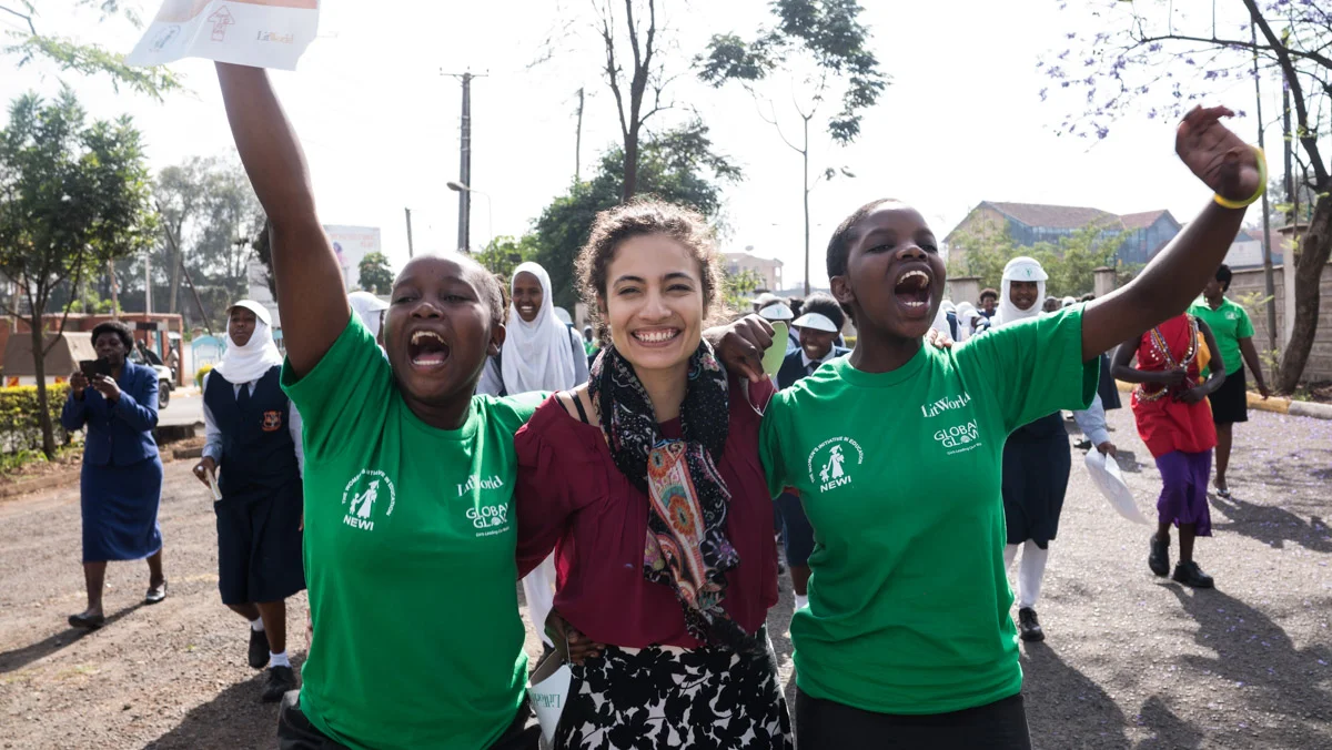 HerStory Director Jennifer Estrada marches with program participants at the conclusion of the National HerStory Summit in Kenya in 2016.