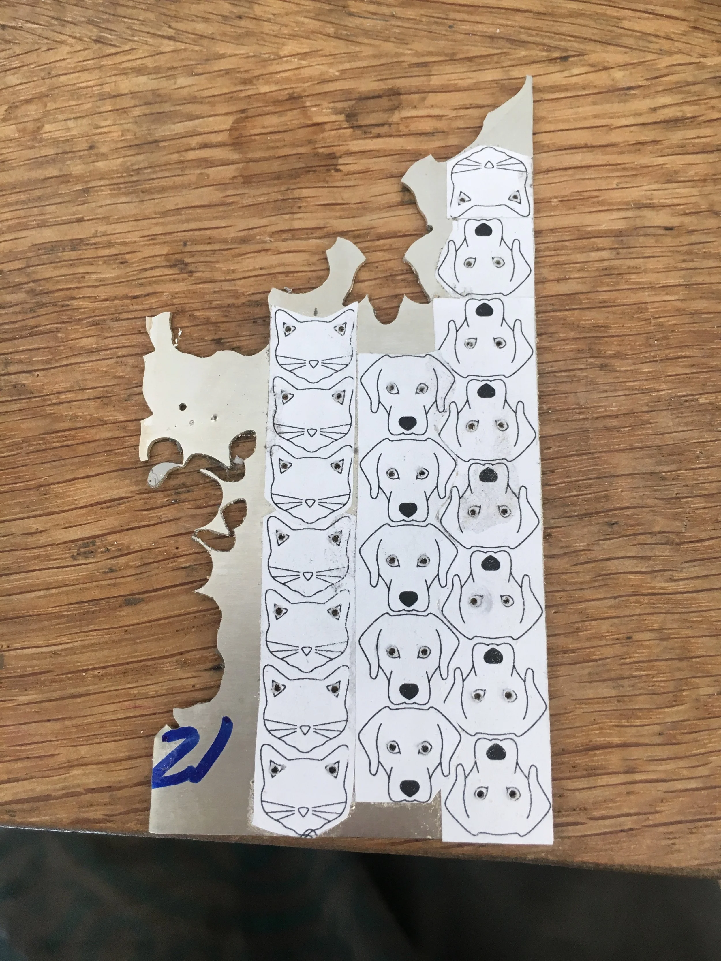 I rubber cement the animals to sterling silver, and drill tiny holes for the eyes and ears.
