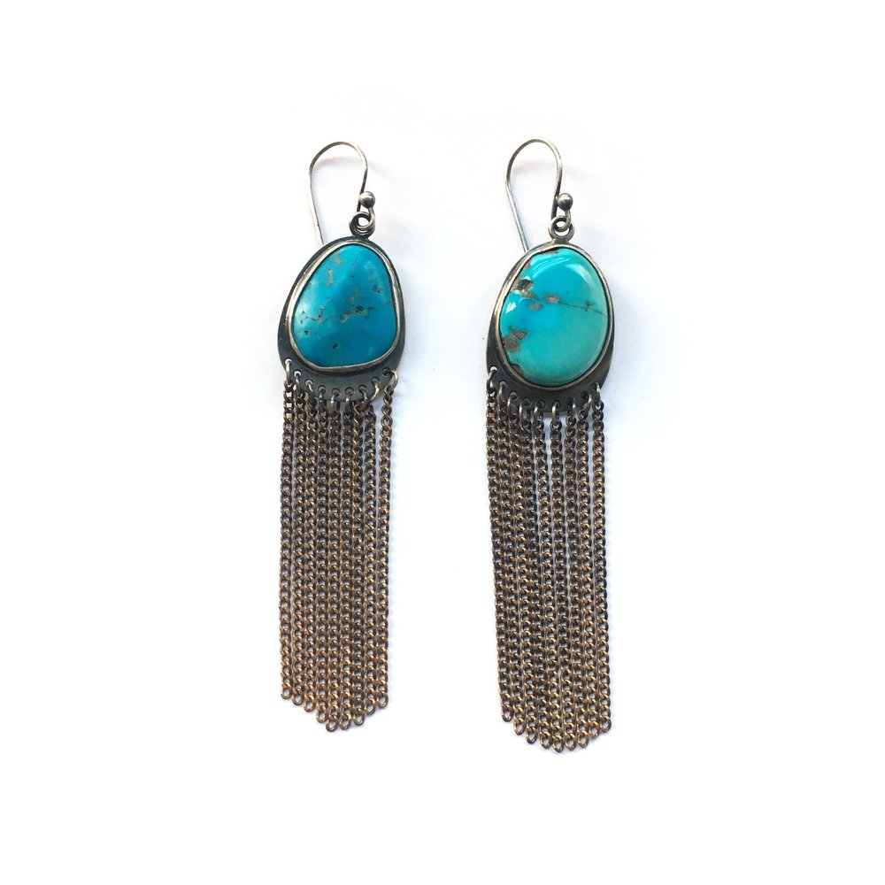 Geometric turquoise fringe earrings with black and silver accents.
