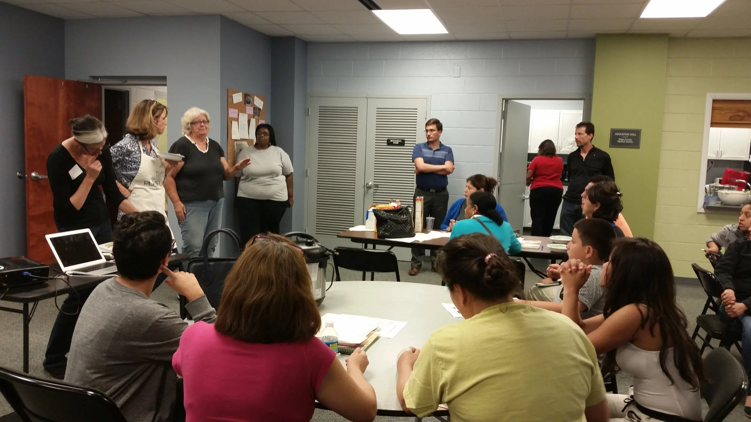 Kim Campbell (second from the left) discussing plant-based nutrition with Cooking Matters participants.