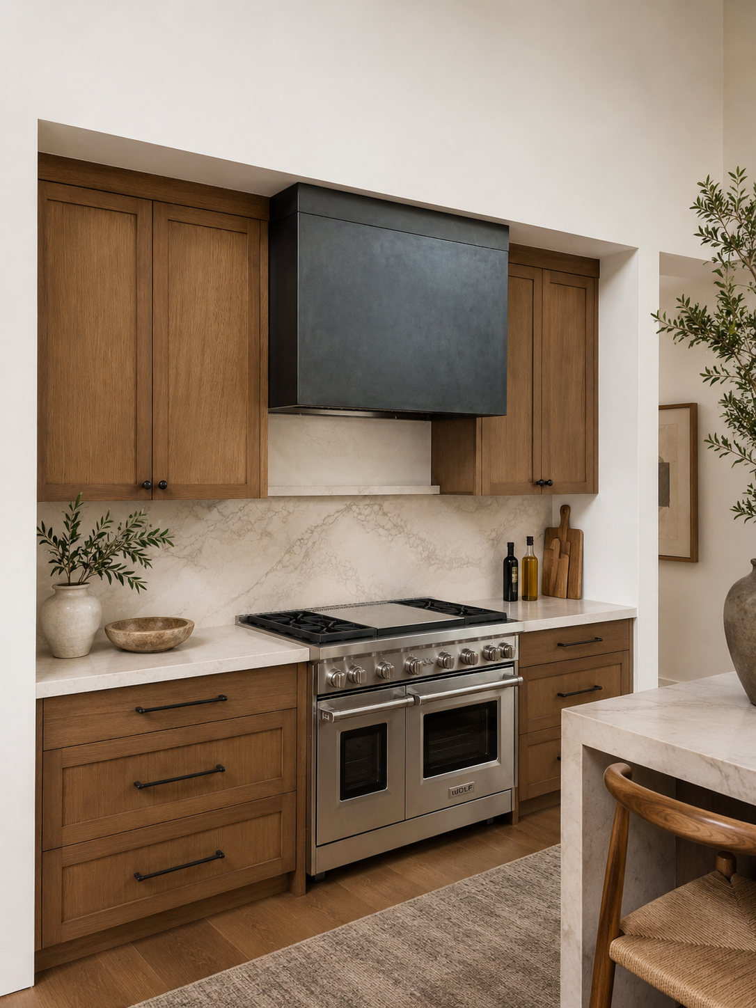 Modern kitchen with wooden cabinets, marble backsplash, stainless steel oven, and black range hood, decorated with potted plants and kitchen accessories.