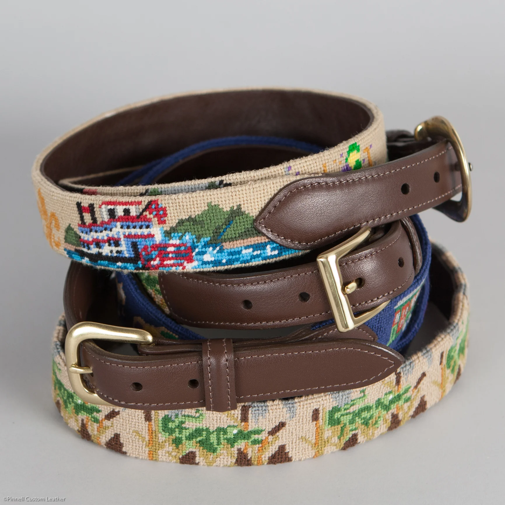 Needlepoint belts, calf tabs, brass buckles