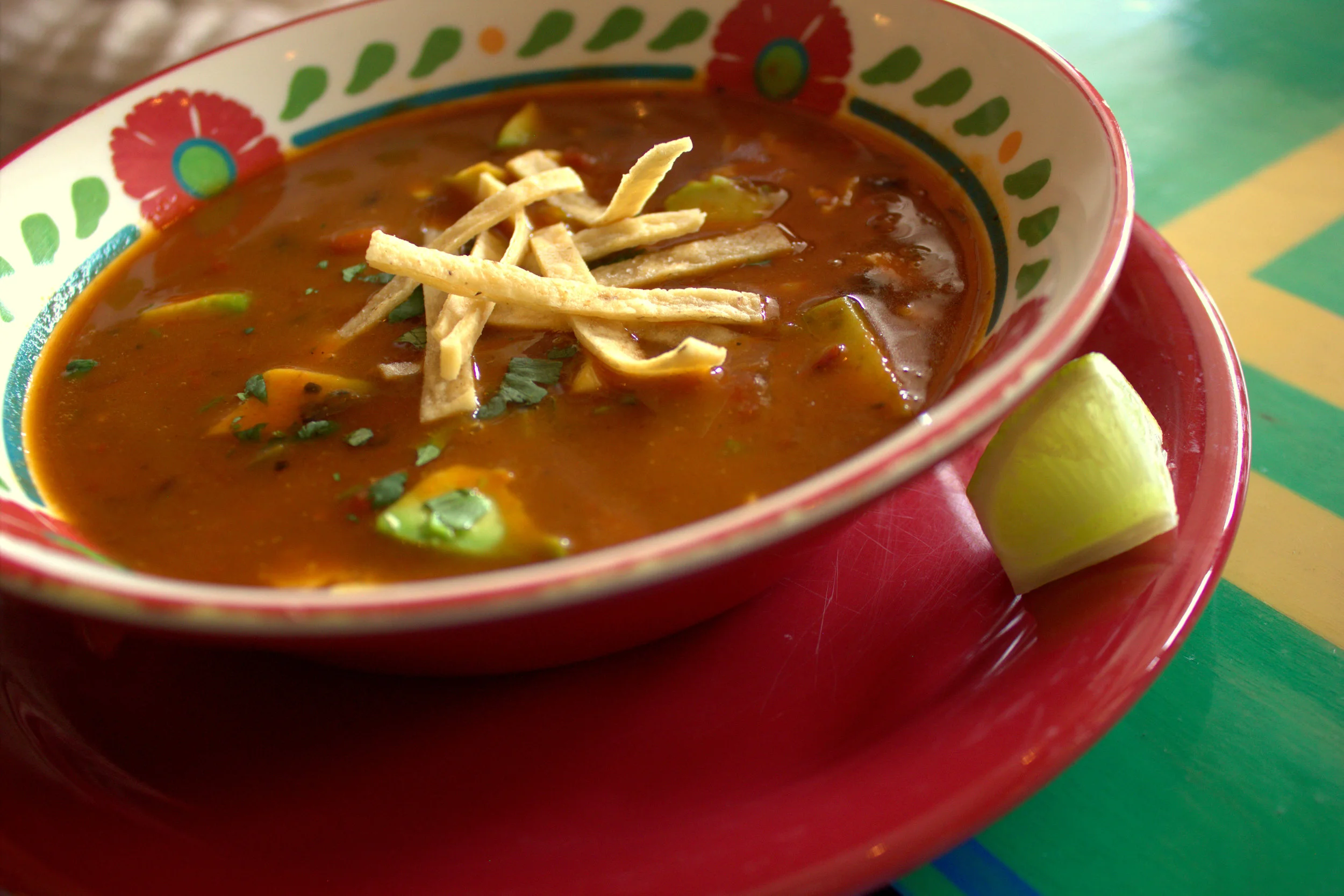 Tortilla soup, with fresh veggies and chunks of avocado
