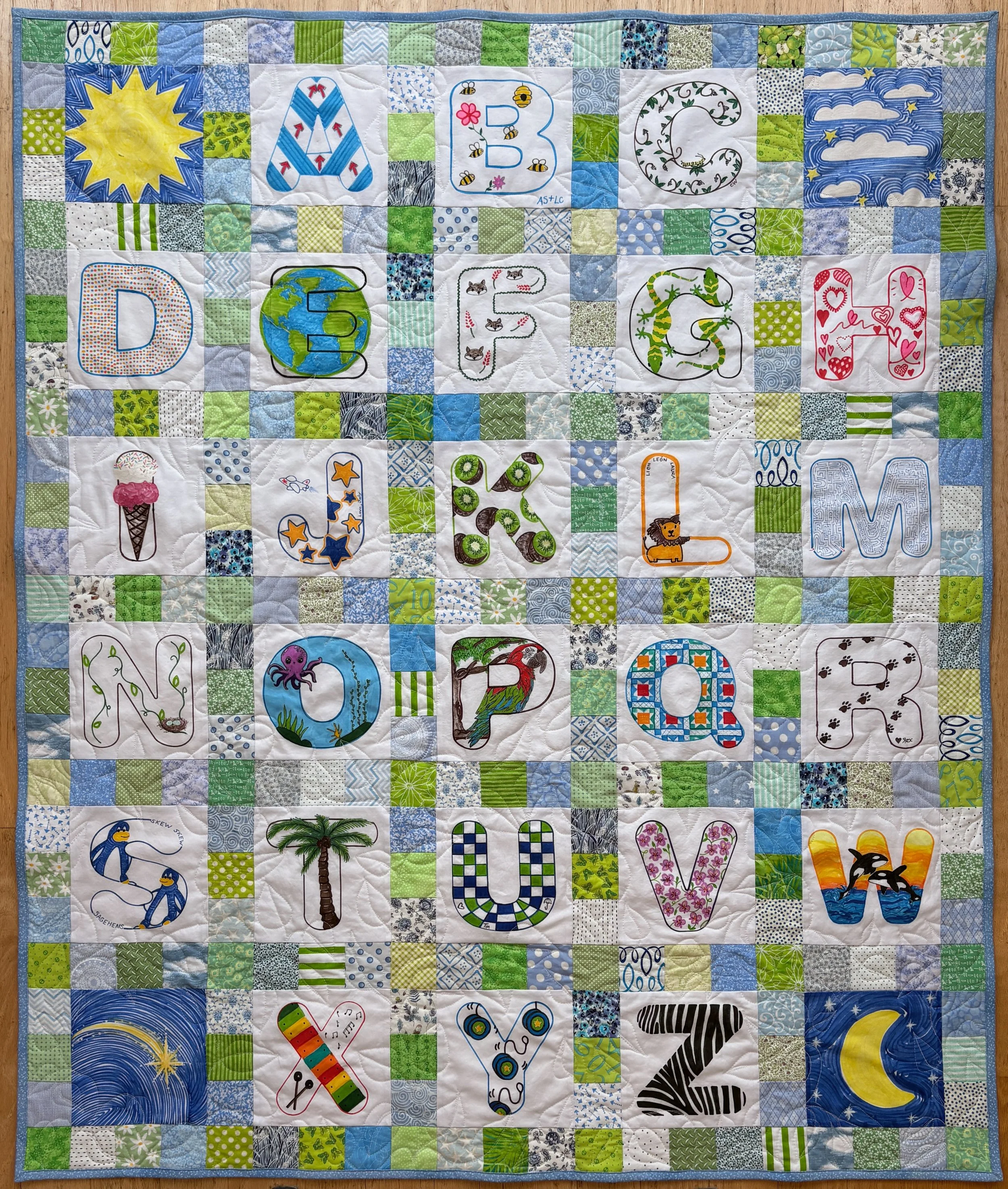 Quilt with combo of light blue and light green surrounding squares