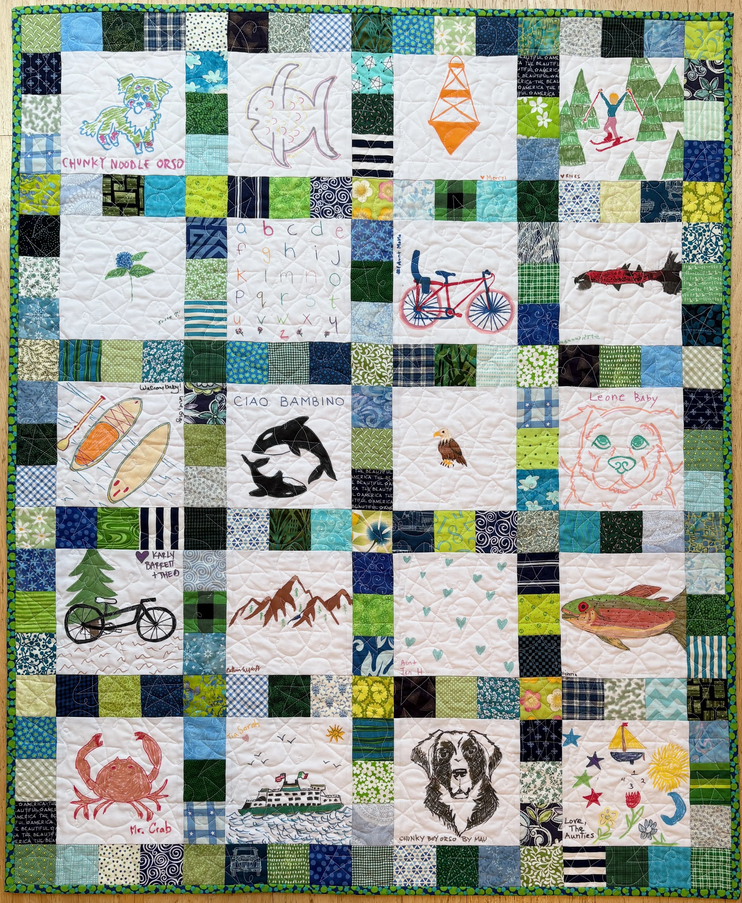 Quilt with blue and green fabrics as surrounding squares