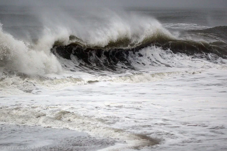 See how the sand darkens the water and how close the waves are breaking to the shore?