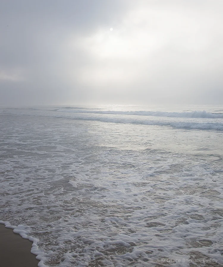 Here is the sun, just breaking through. See the lace in the water?