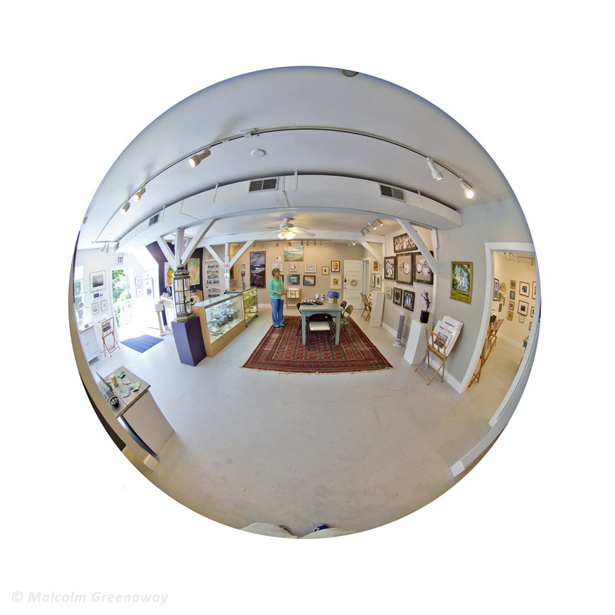Here is the interior of the Spring Street Gallery. My work can be seen in miniature, around the front door, but what you can really see is the rug. That's my rug. And, just to give you an idea of how a fish eye lens works, that odd little shape at the bottom of the picture is the bottom of Malcolm's legs and the top of his feet. 