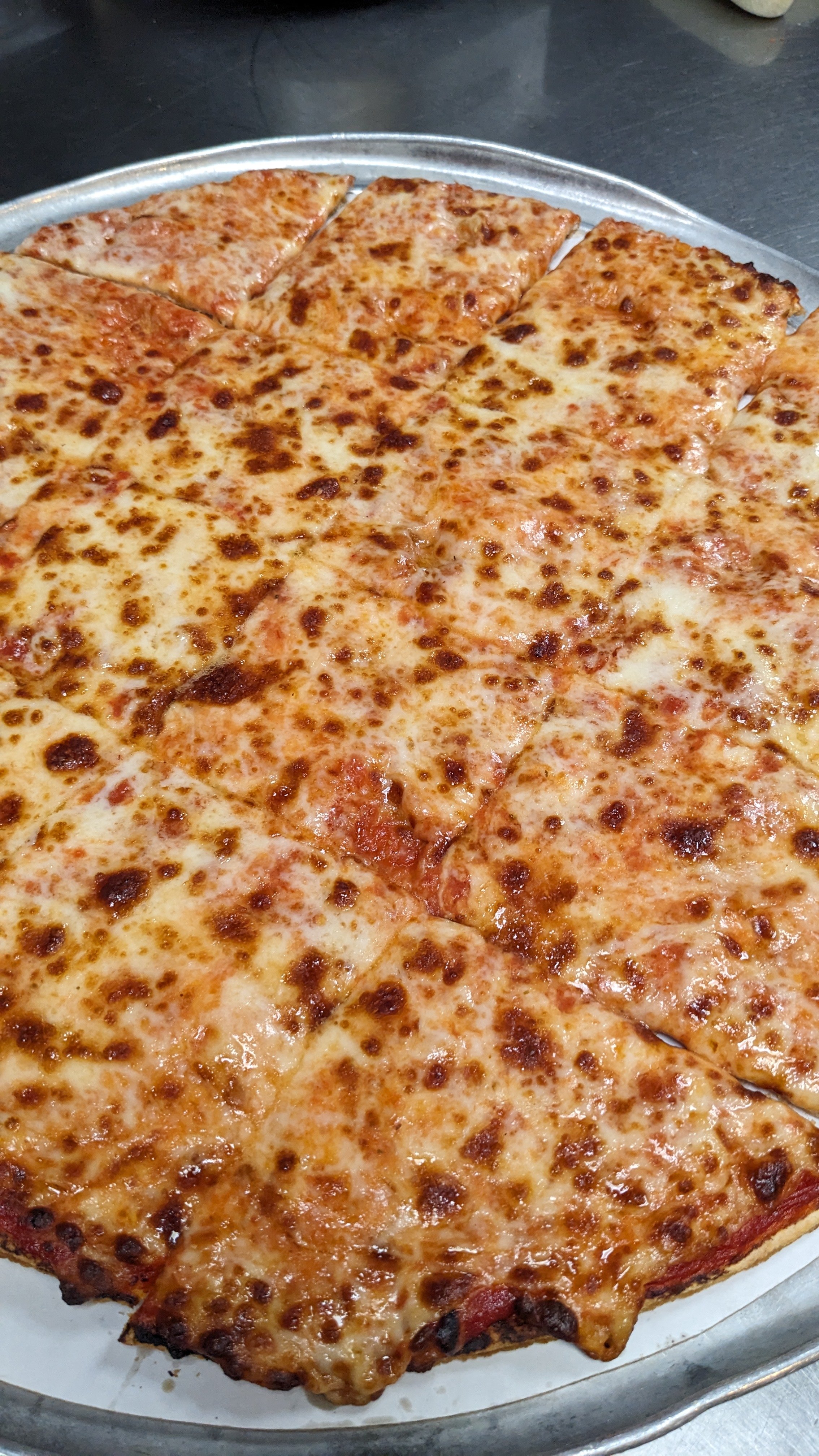 Cheese pizza on a silver tray.