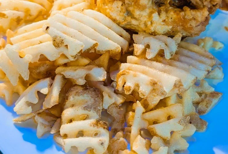 Close-up of cooked pasta with some fried chicken on top.