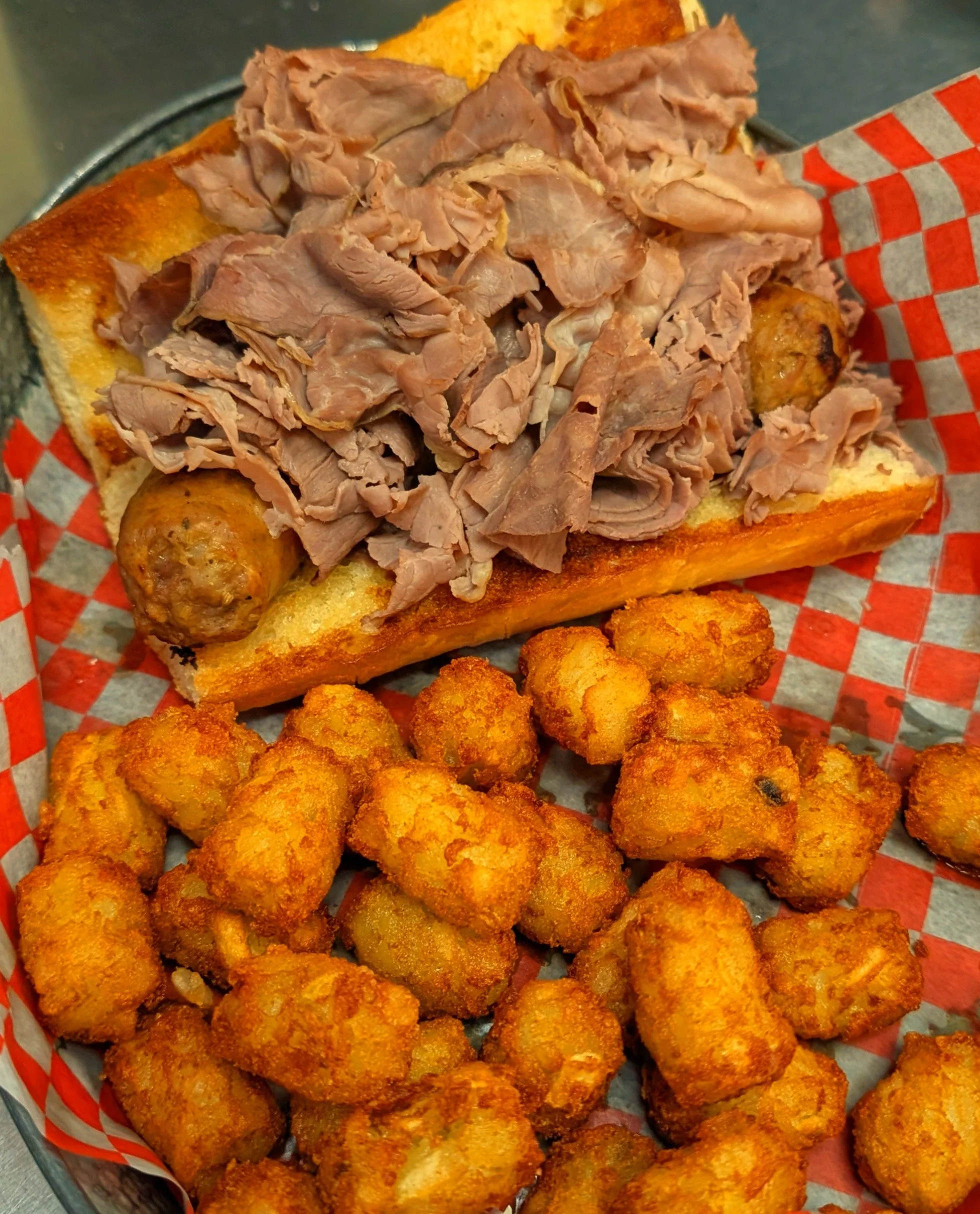 Roast beef sandwich with bread pudding and tater tots.