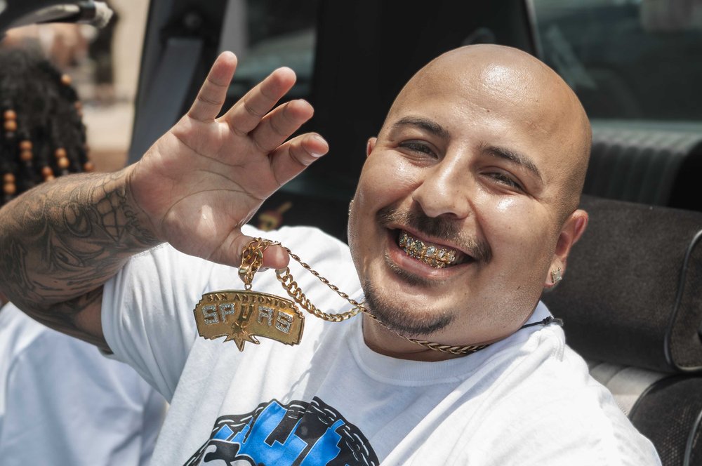  A guy smiles and shows off his bling-bling. 