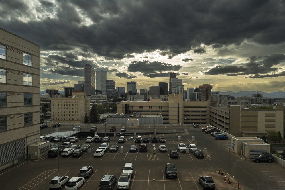  The ominous skies illuminate the Denver skyline. 
